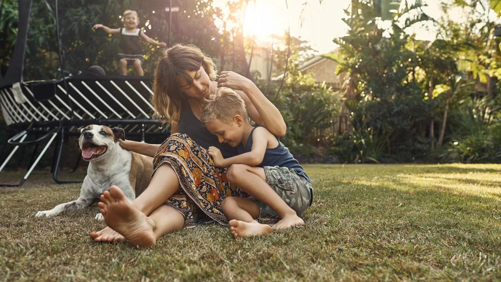 Shot of a young mother hanging outside with her son and daughter